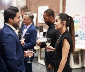 Business Team Socializing At After Works Drinks In Modern Office