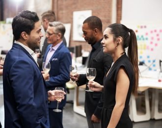 Business Team Socializing At After Works Drinks In Modern Office